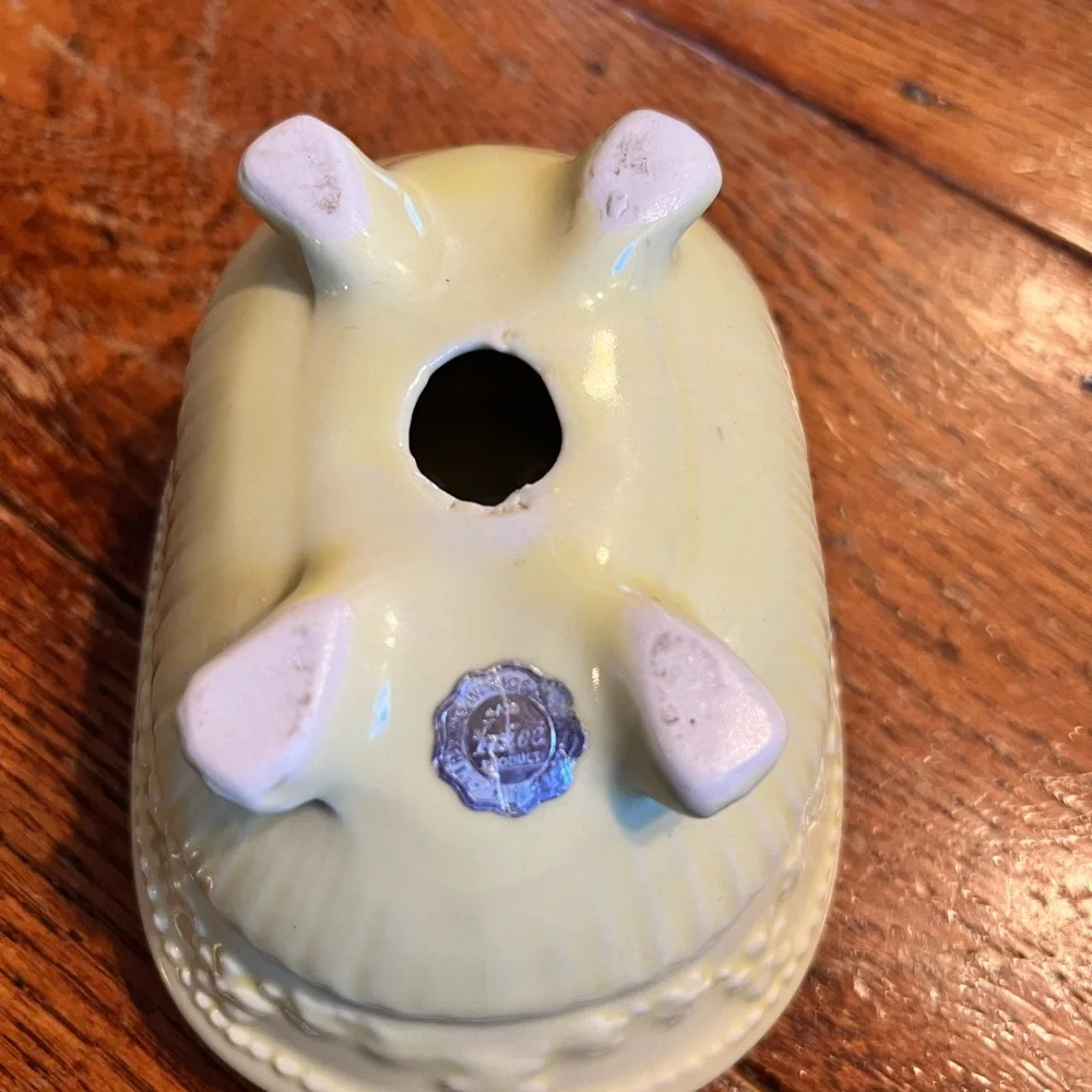 Vintage butter yellow ceramic soap dish shaped like bathtub.